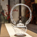 Glass teapot with large basket handle